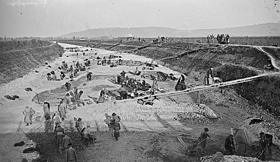Italian women workers collecting stones from the river bed for road construction.